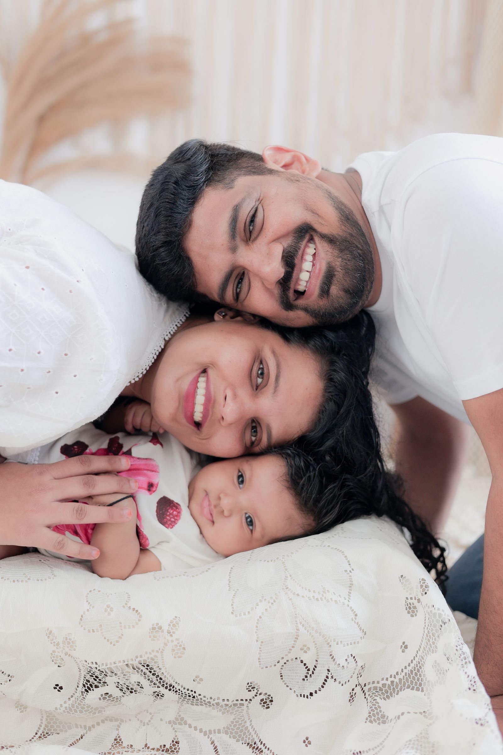 Parents and their baby smiling together